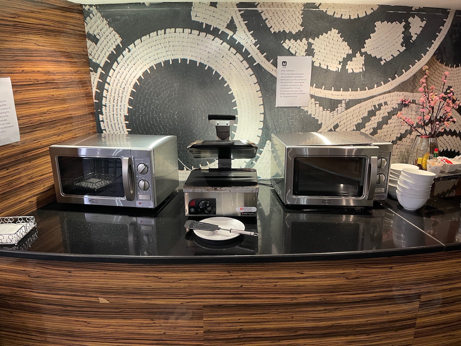 a group of microwaves on a counter