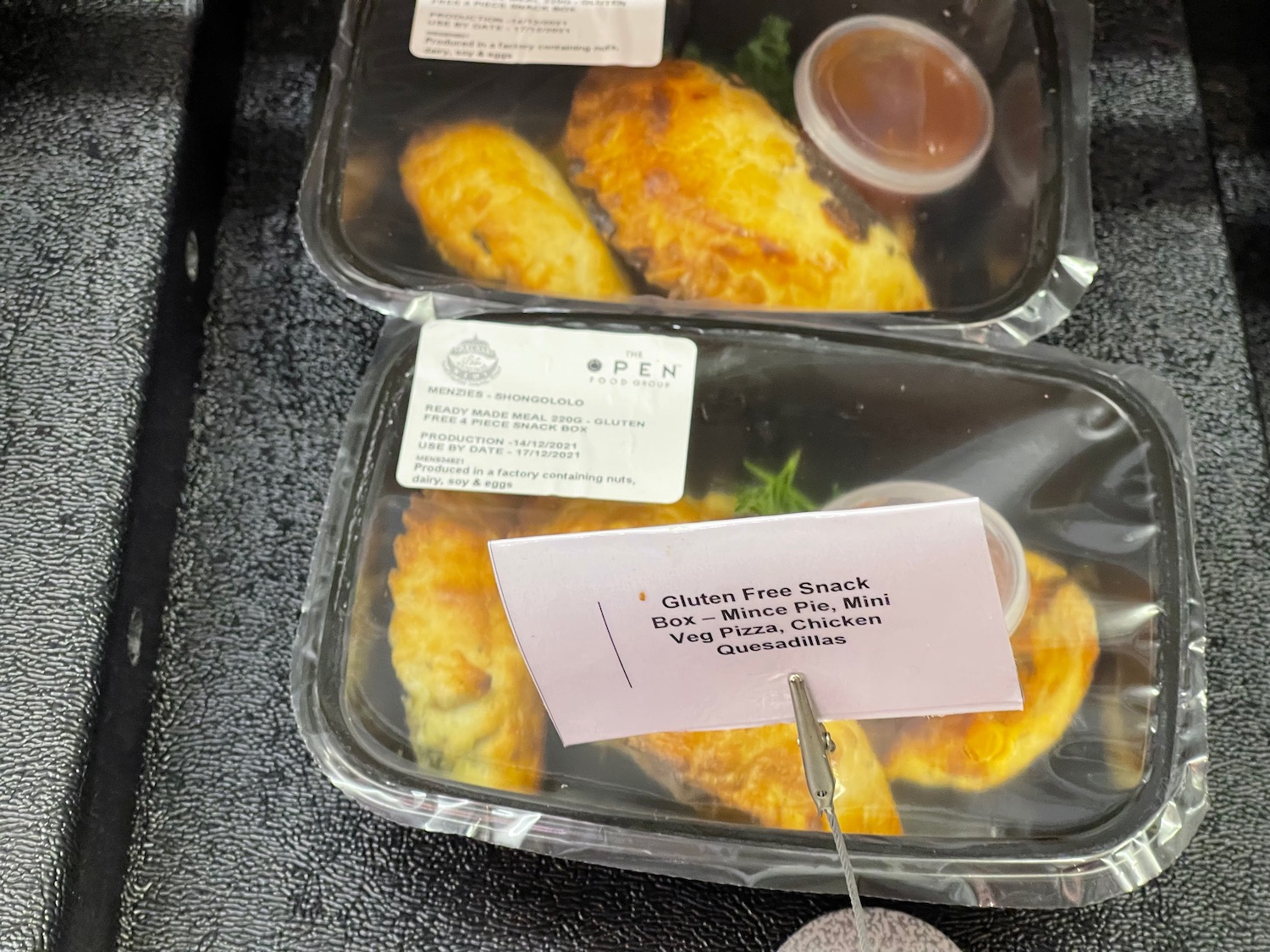 a trays of food with a paper tag