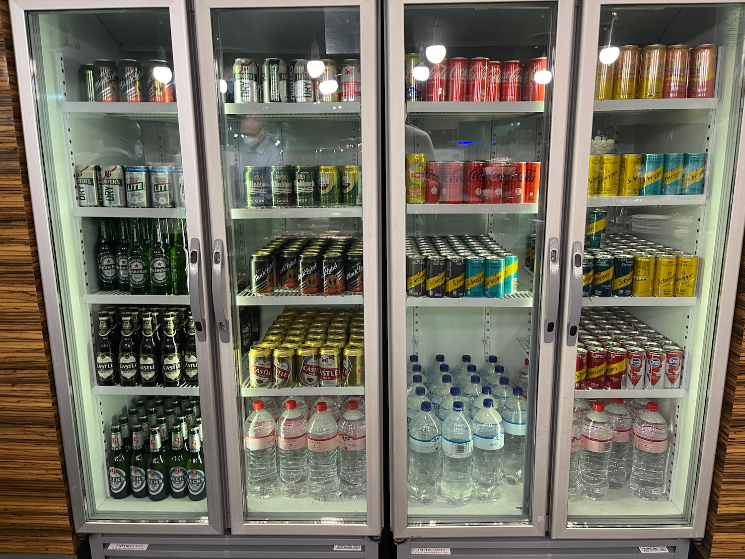 a refrigerator with drinks and cans