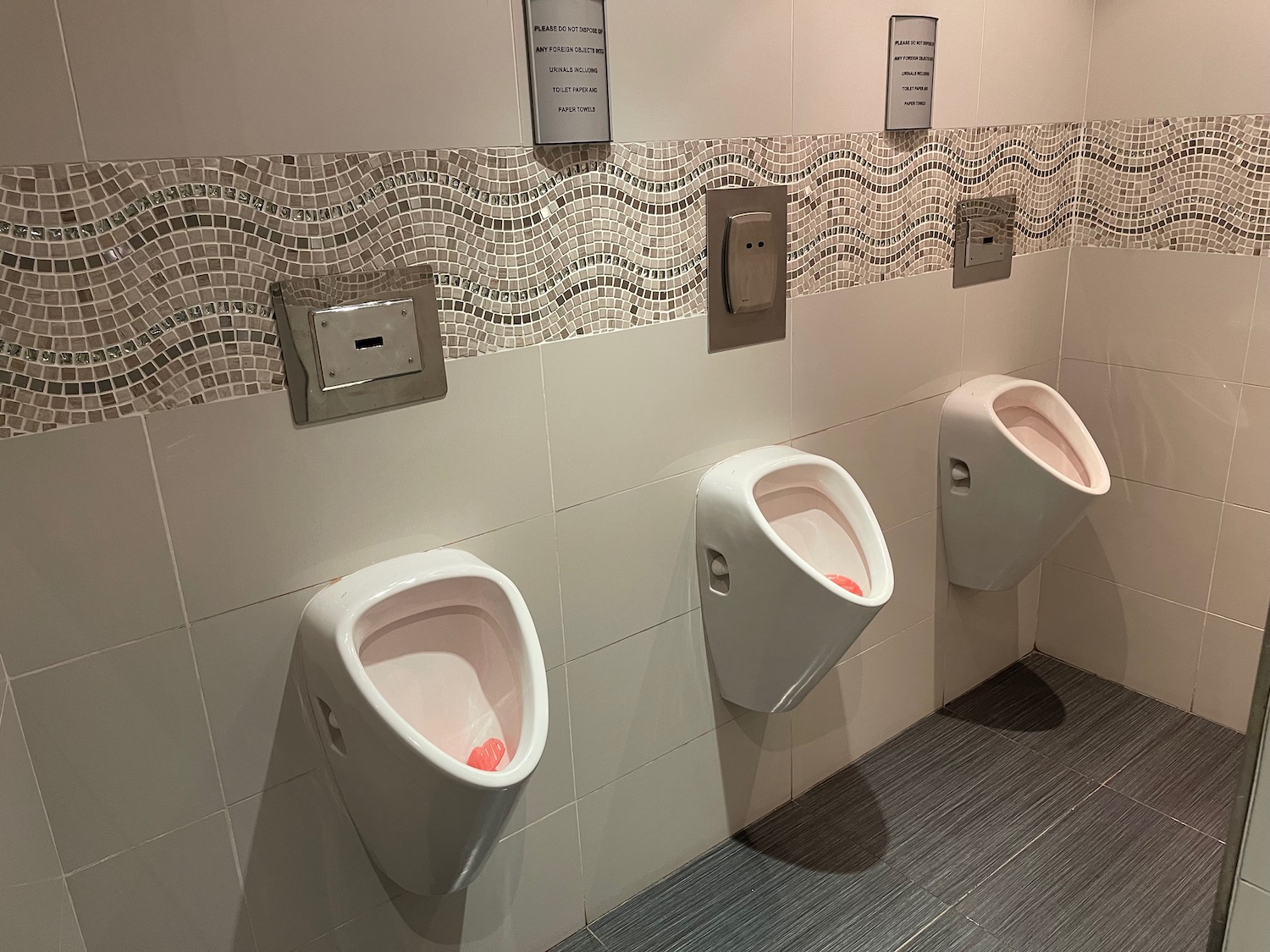 a row of urinals in a bathroom