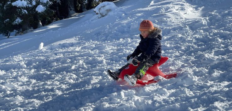 a child on a sled in the snow