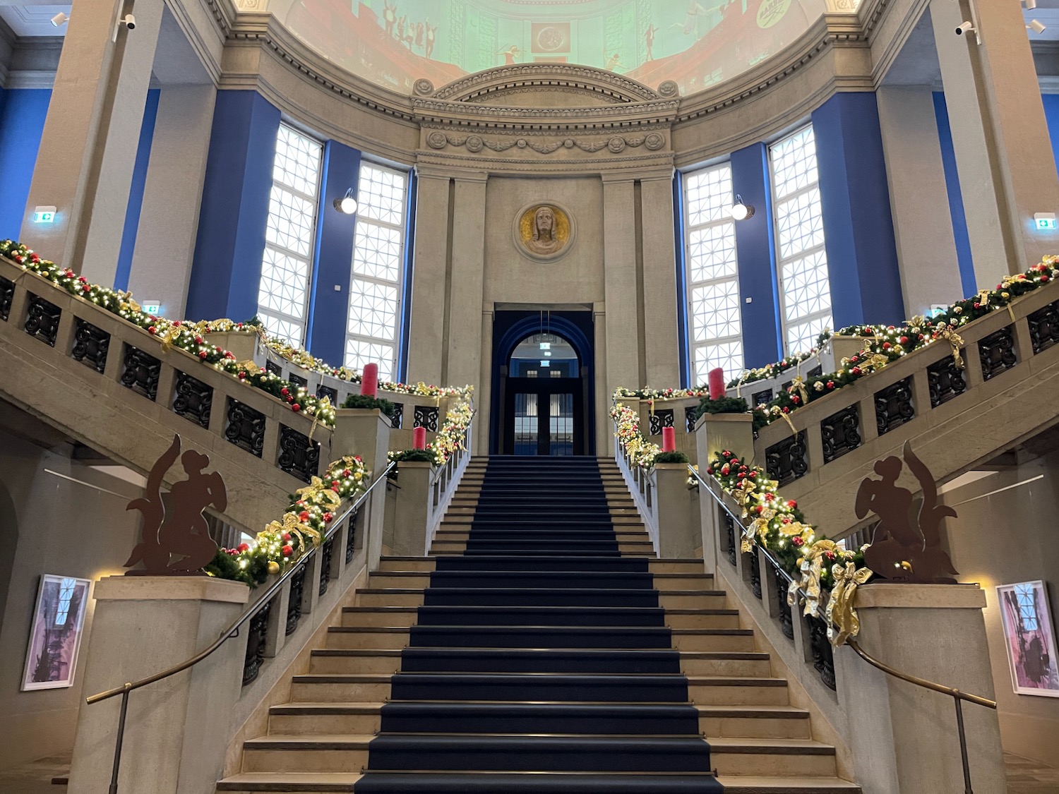 a staircase with blue carpet and blue railings