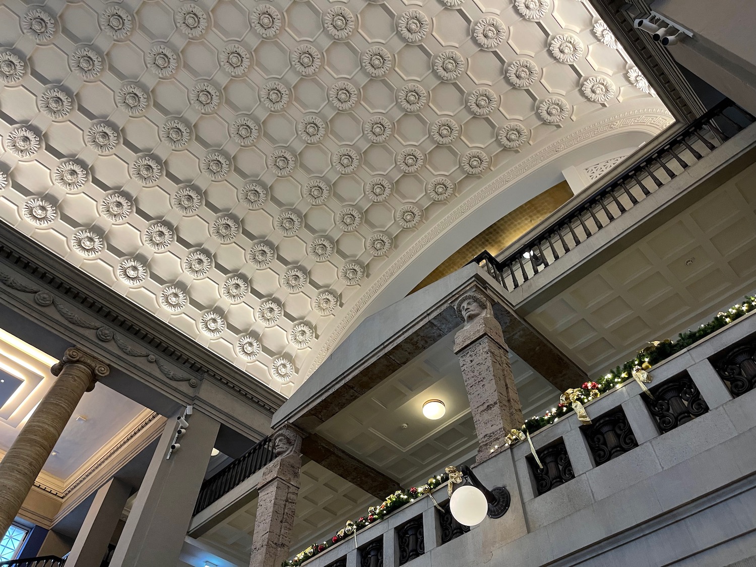 a ceiling with a stone railing and a balcony