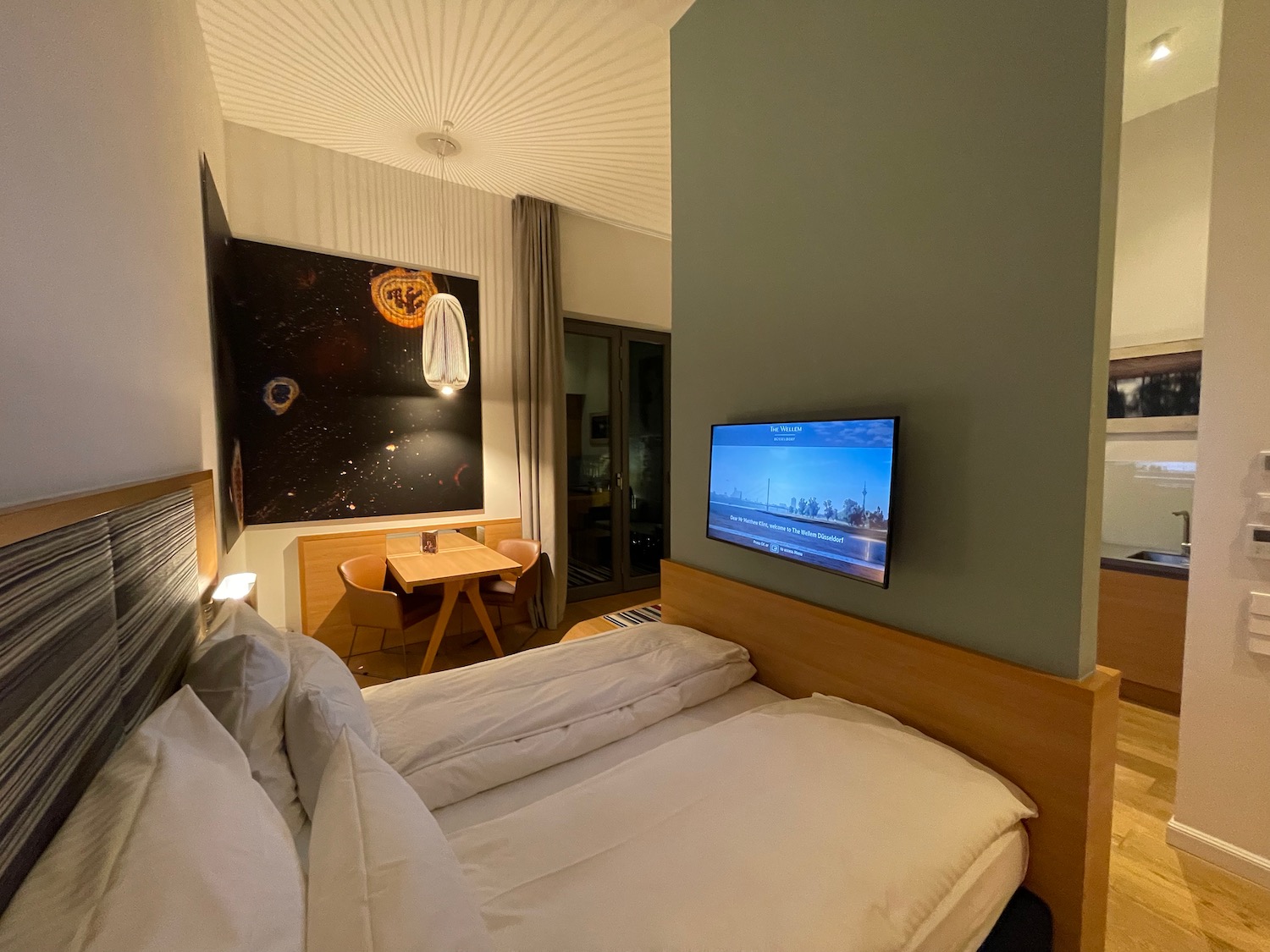 a bed with a tv on the wall