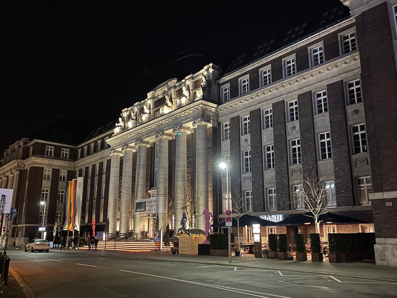 a building with columns and lights at night