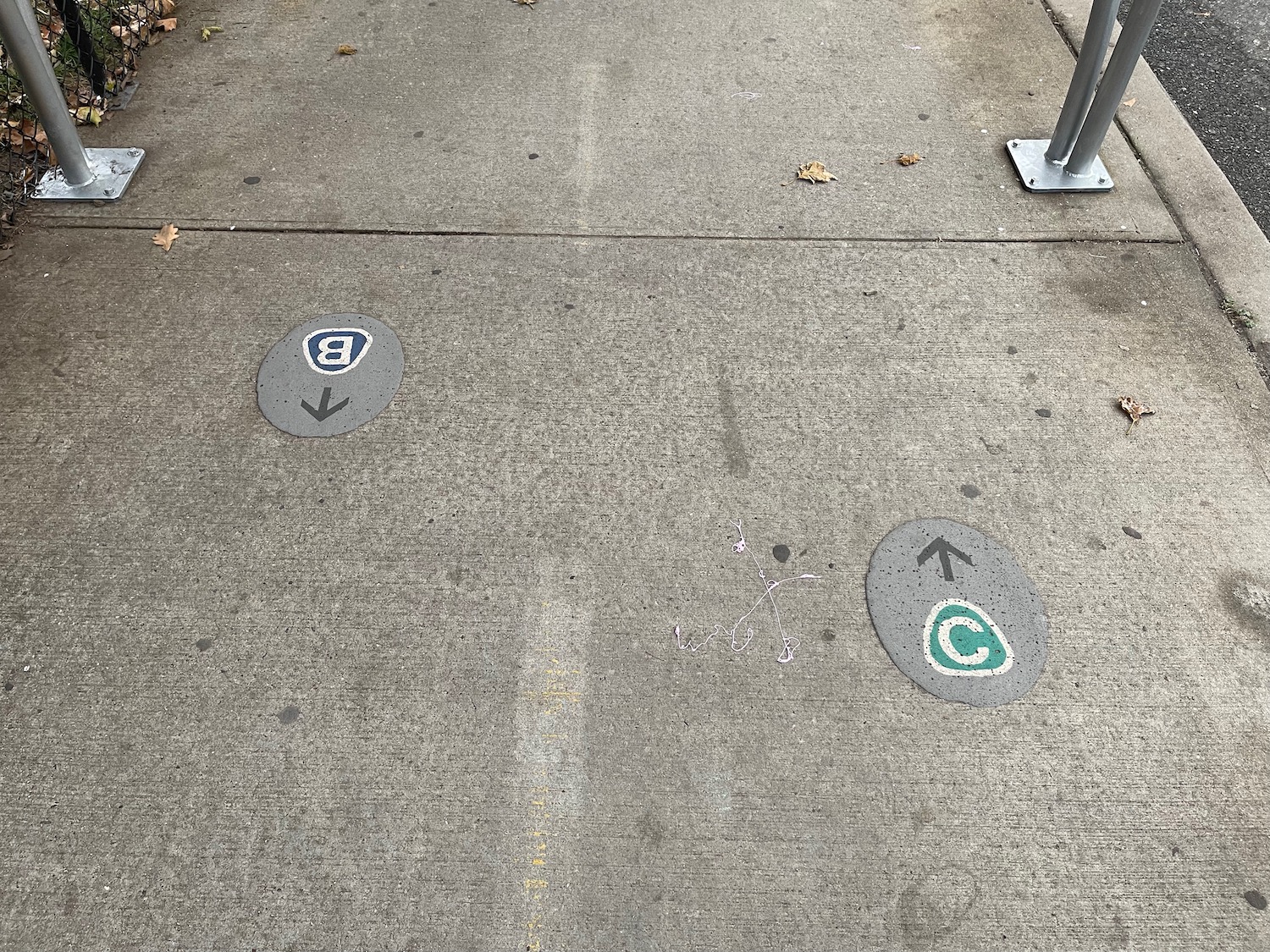 a sidewalk with signs on it