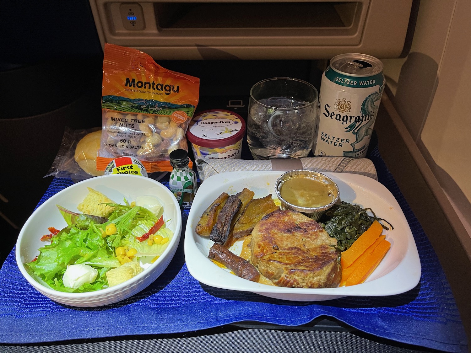 food on a tray in the back of a plane