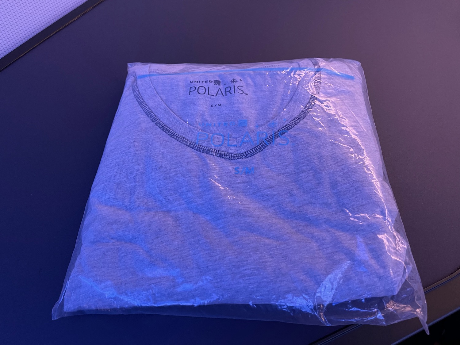 a folded shirt in a plastic bag
