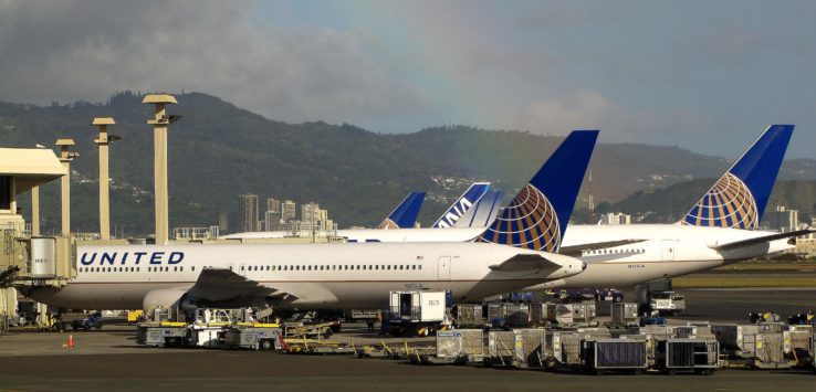 a group of airplanes parked at an airport