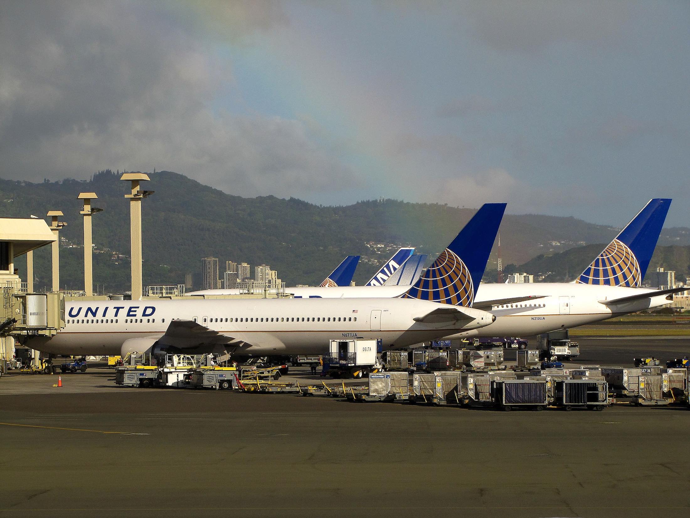 a group of airplanes parked at an airport