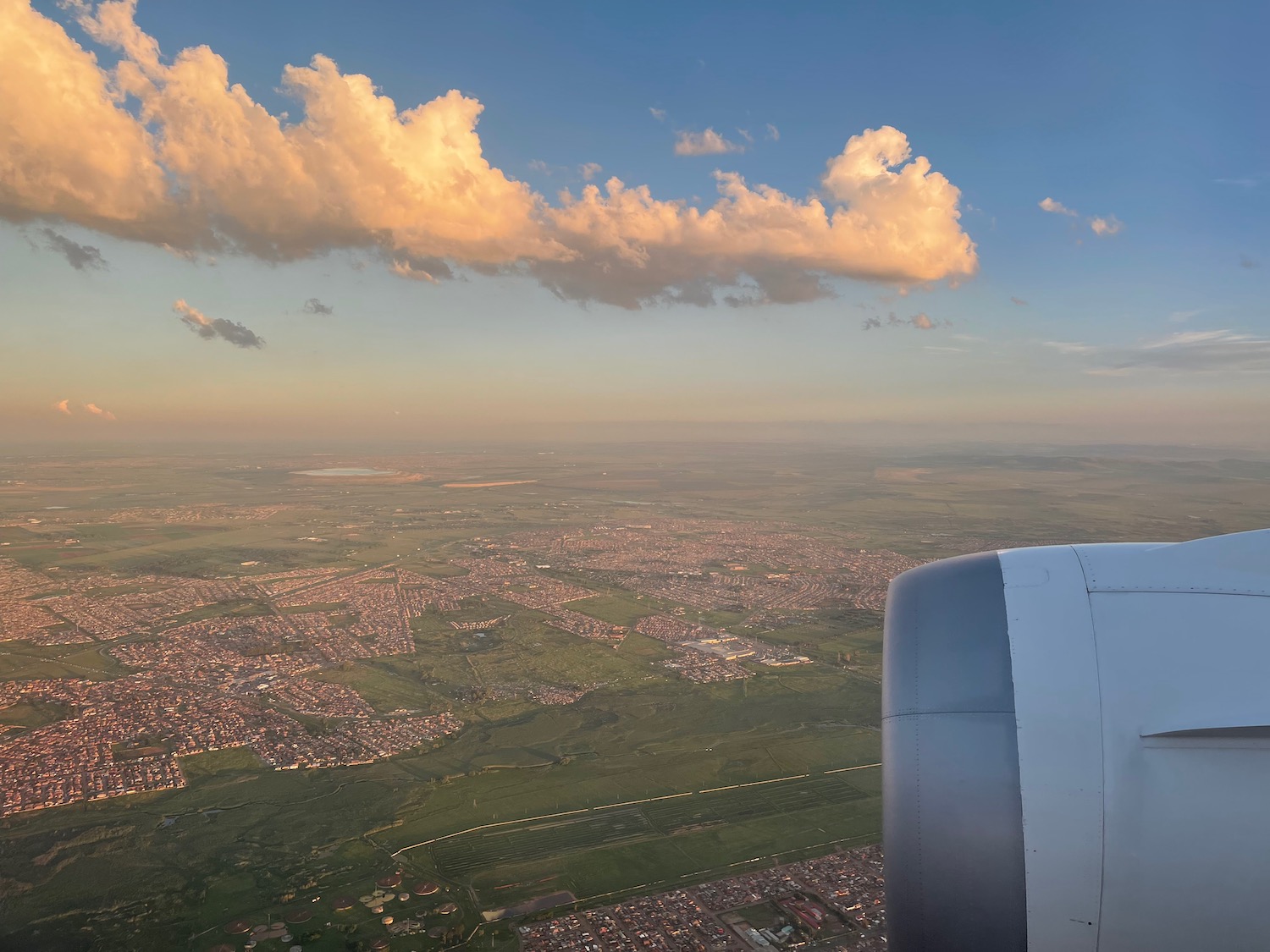 an airplane wing and a city