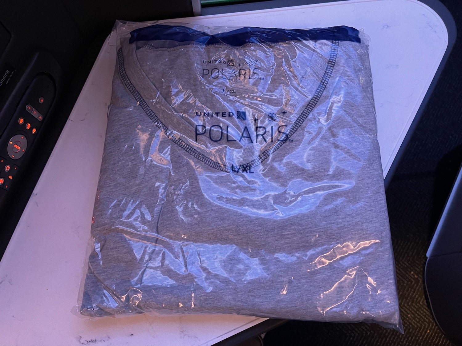 a grey shirt in a plastic bag