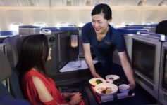 a woman serving food to another woman