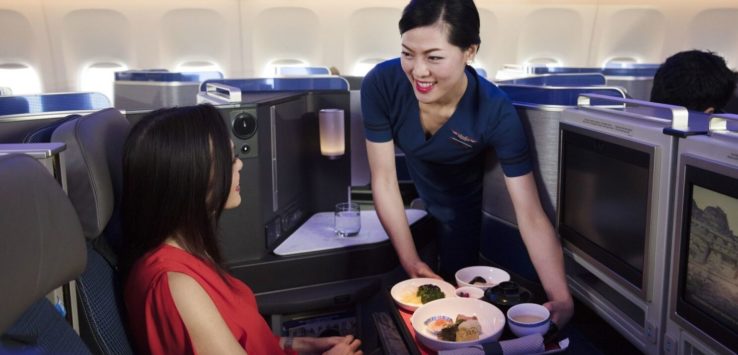 a woman serving food to another woman