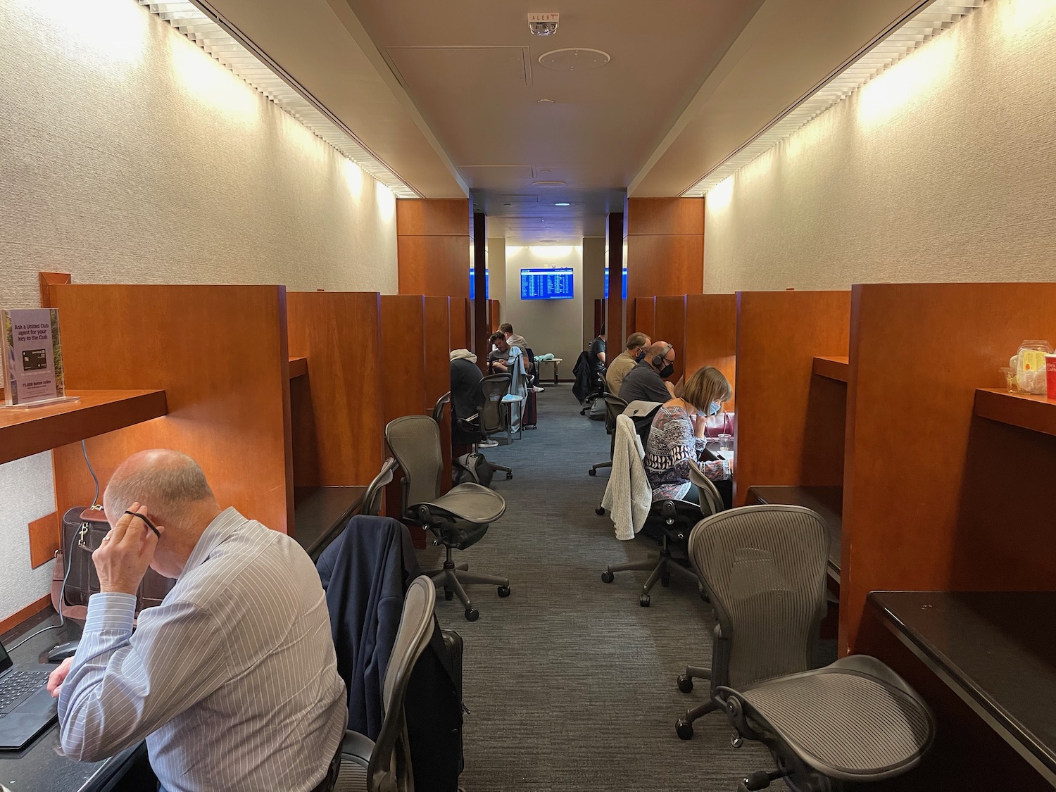 a group of people sitting in chairs in a room with desks