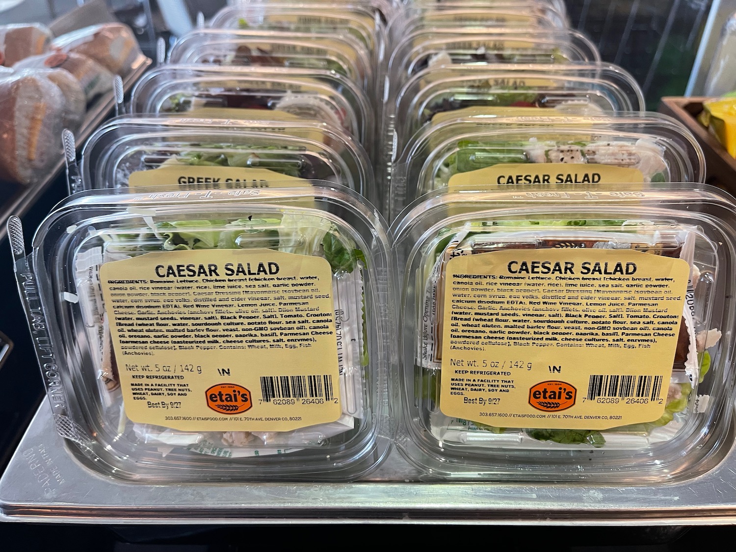 a group of plastic containers of salad