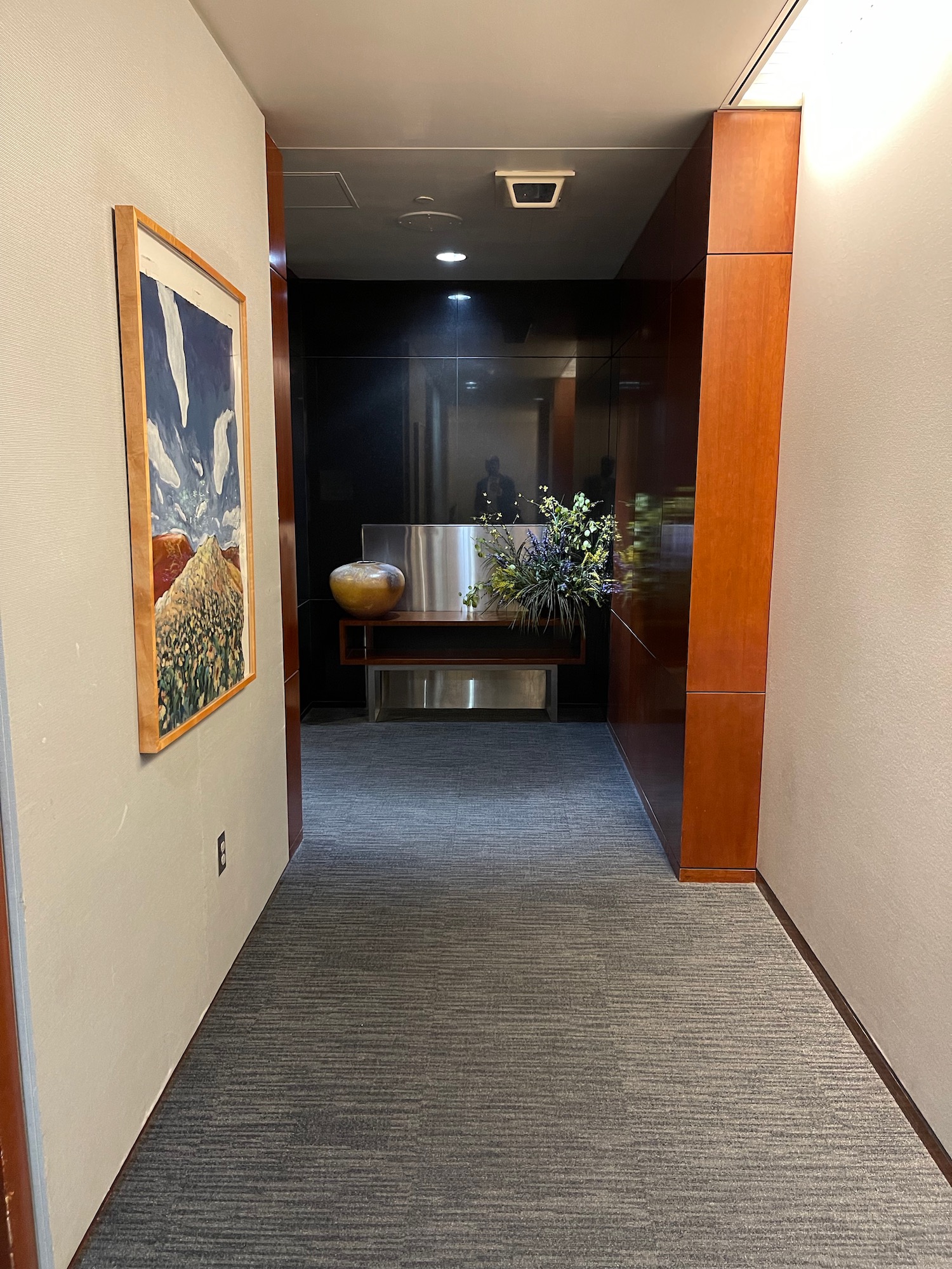 a hallway with a plant on the wall