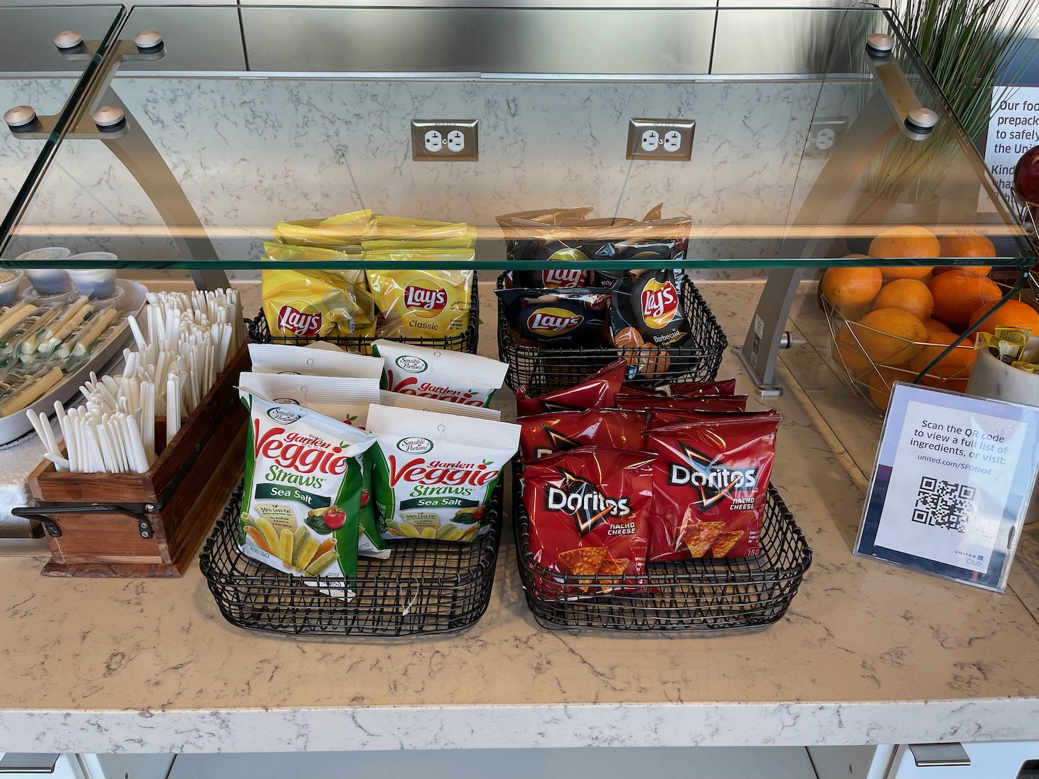 a group of bags of chips and other snacks on a counter