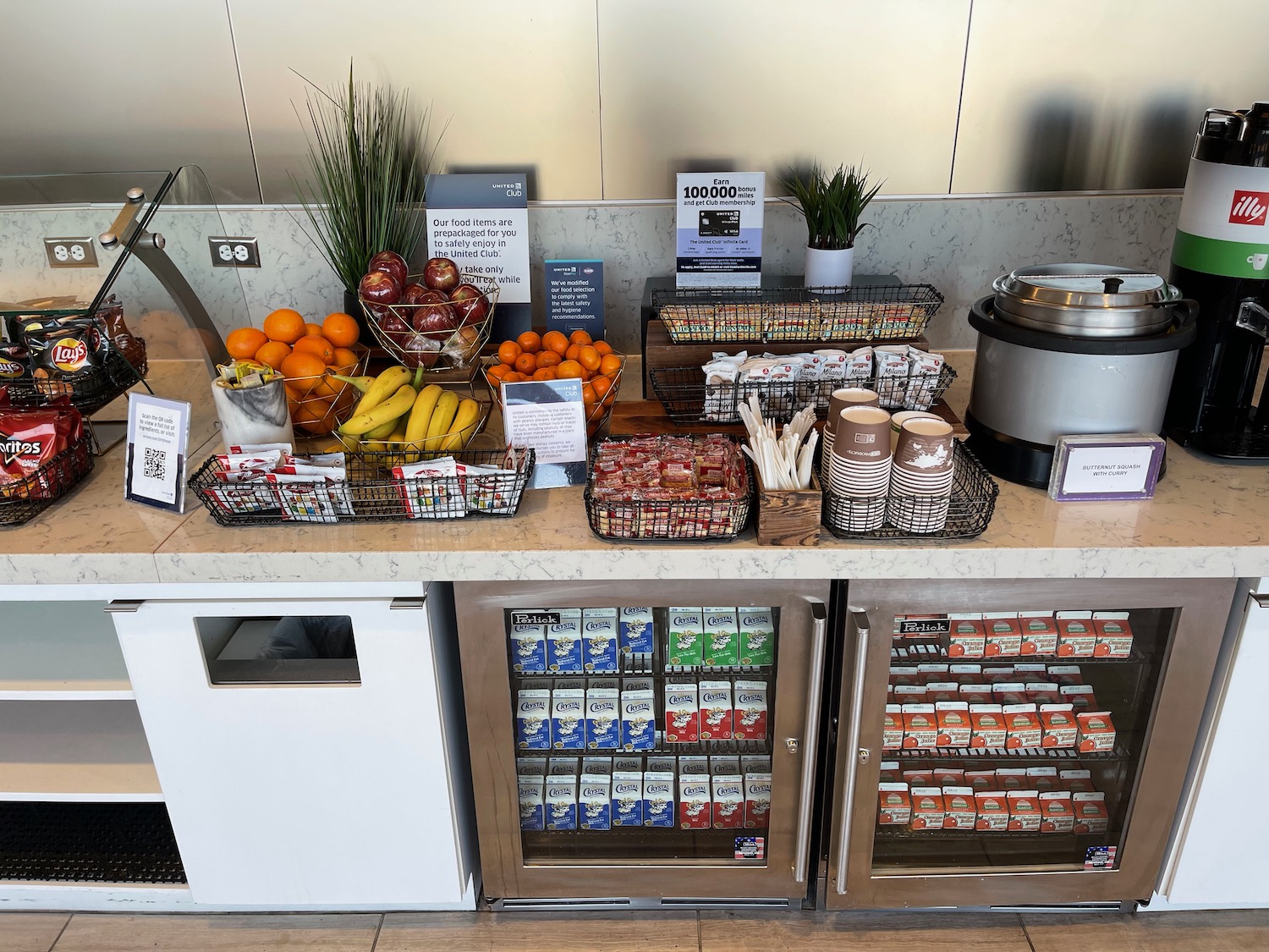 a counter with fruit and drinks on it