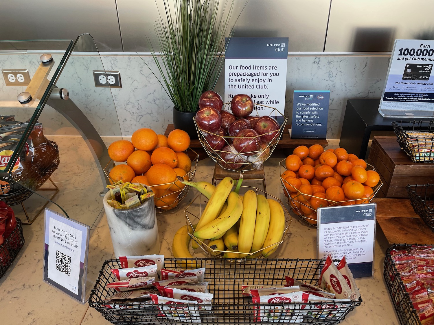 a table with fruit and a sign