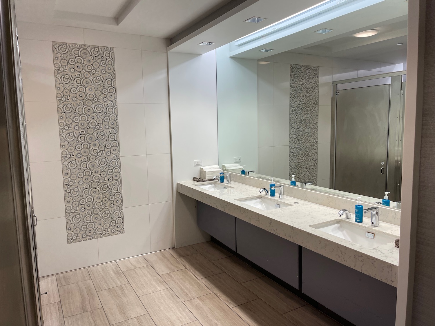 a bathroom with sinks and a mirror