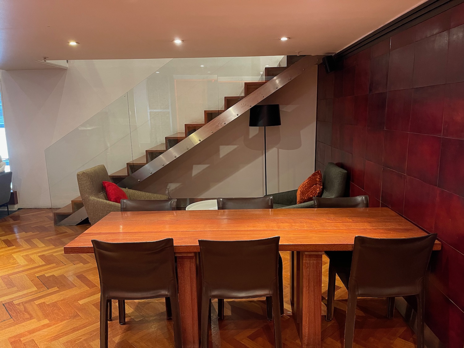 a table and chairs in a room with stairs