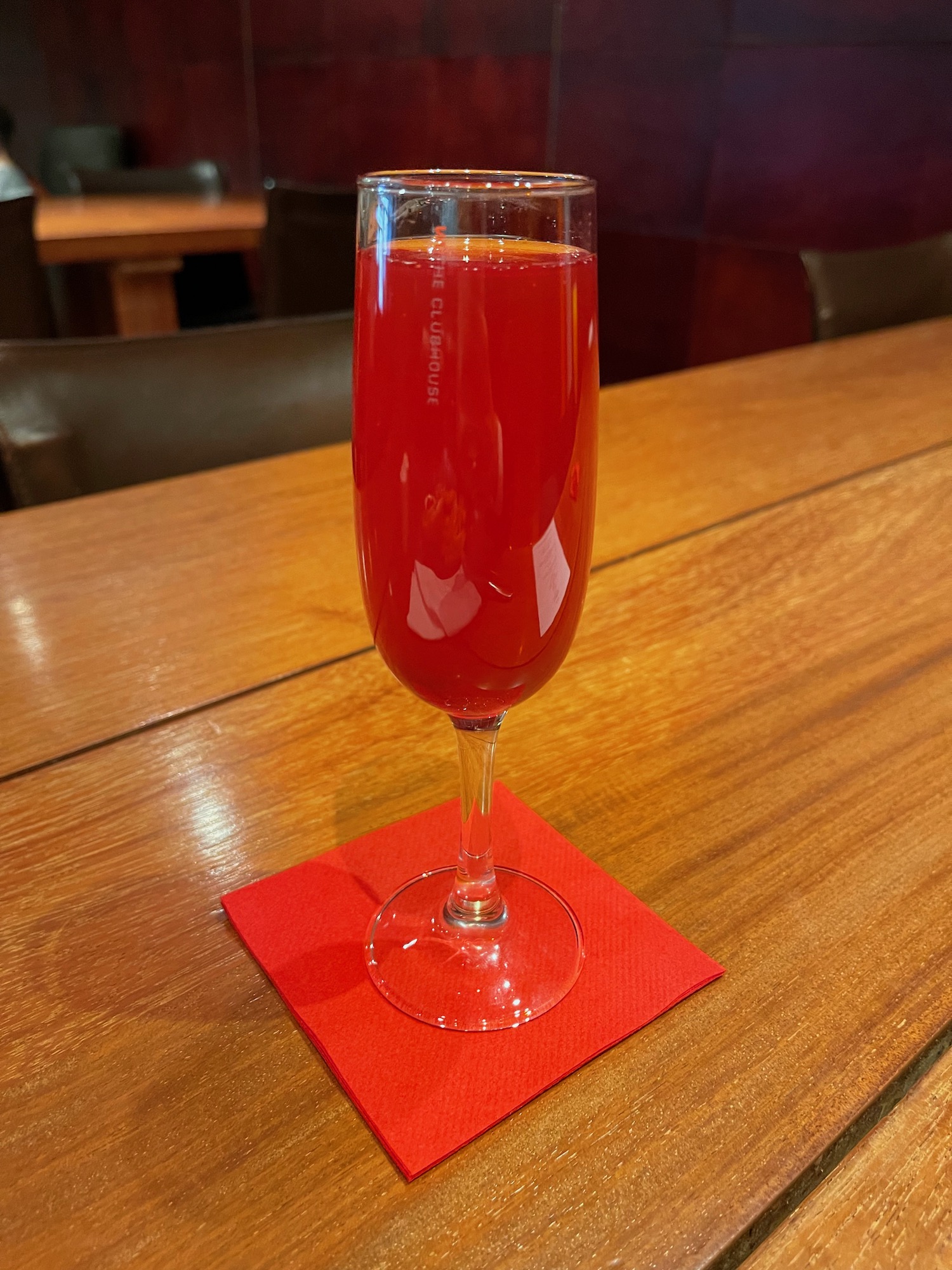 a glass of red liquid on a table