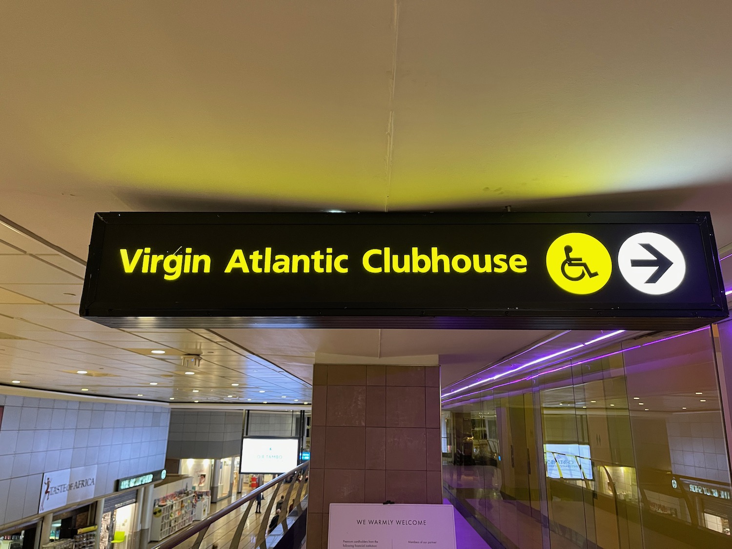 a sign with yellow text and white text