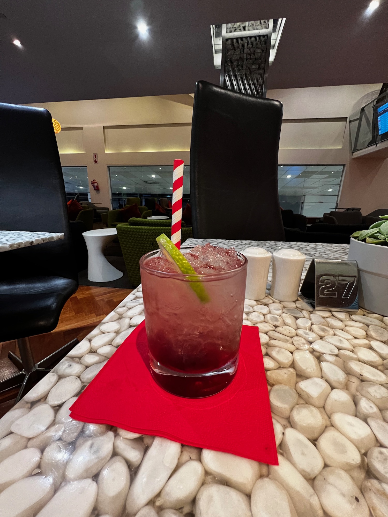 a glass with ice and a straw on a table