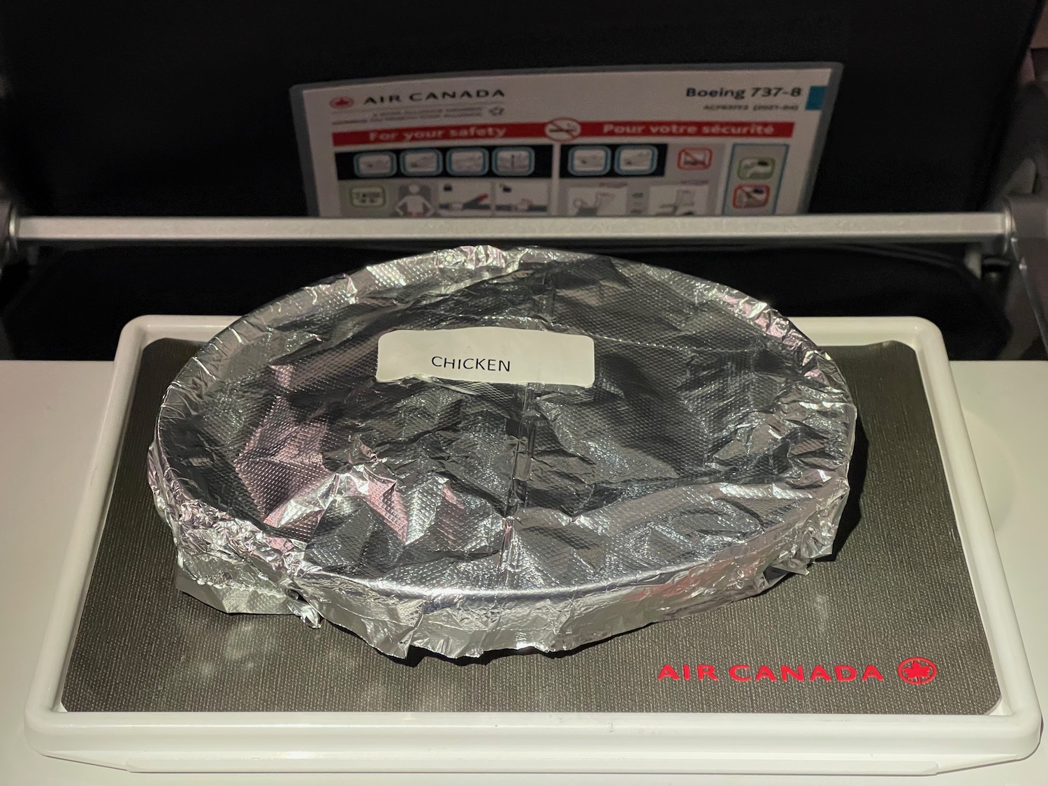 a chicken wrapped in foil on a scale