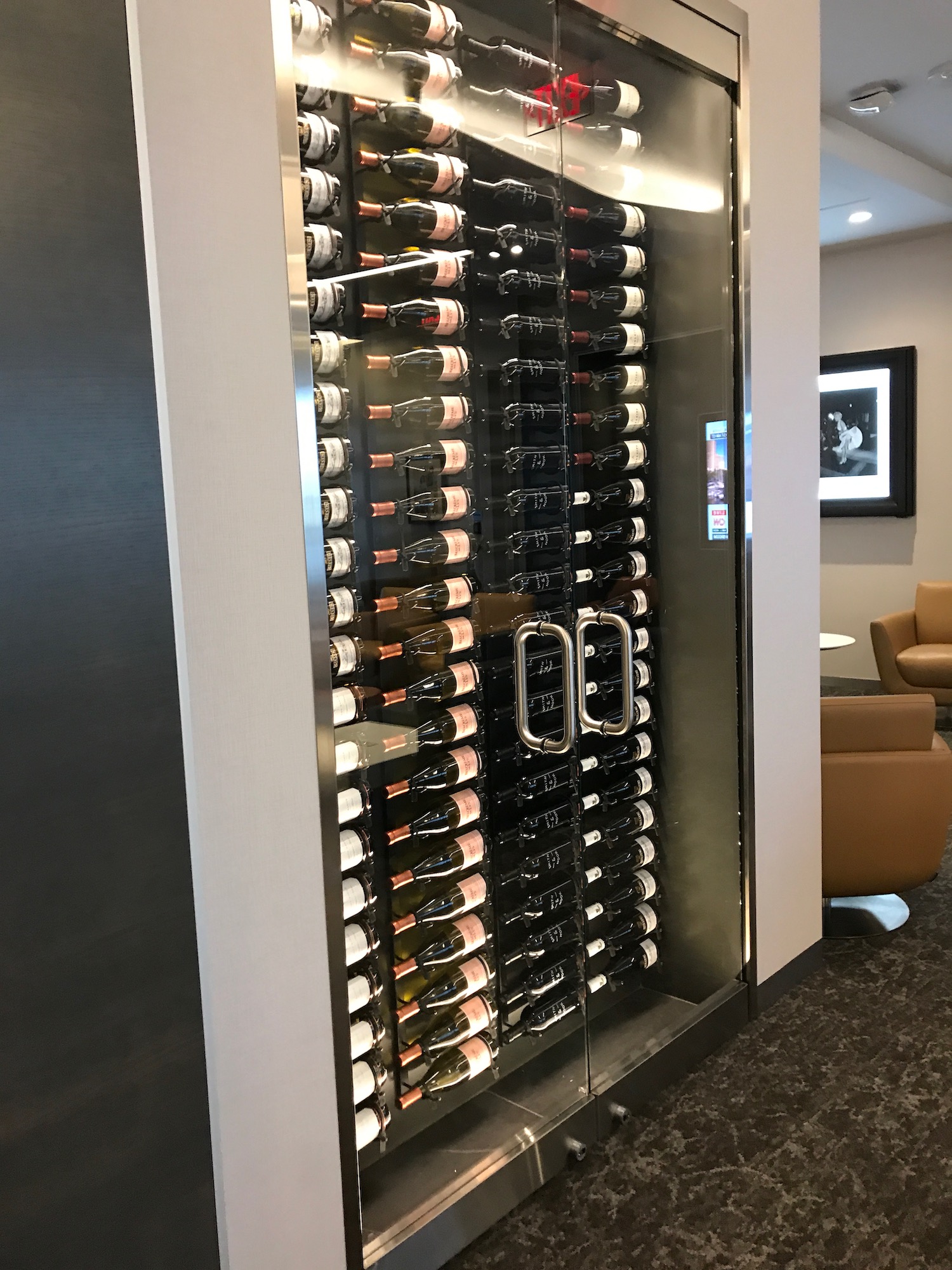 a glass case with bottles of wine