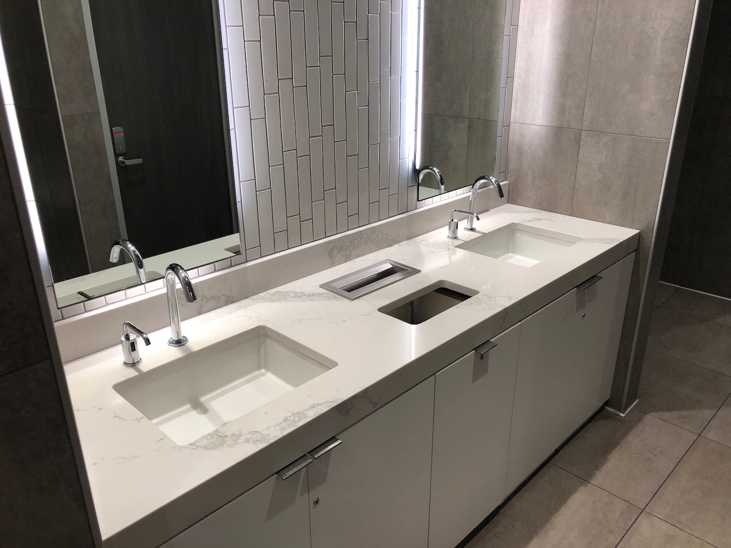 a bathroom with sinks and mirrors