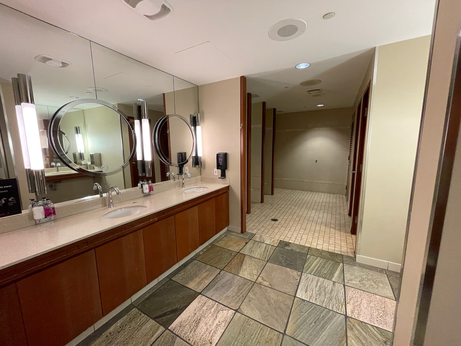 a bathroom with a large mirror and sinks