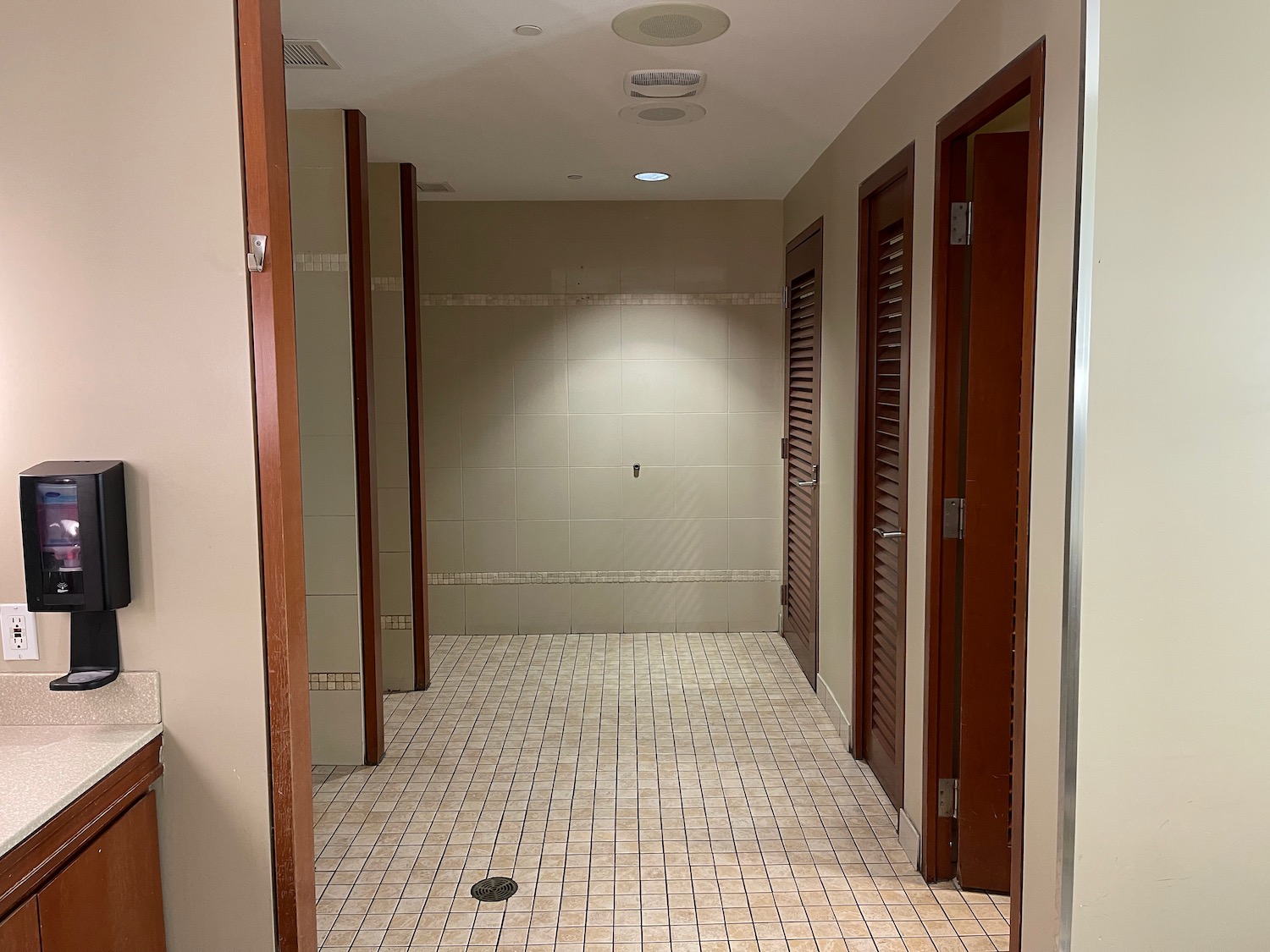 a hallway with doors and a tile floor