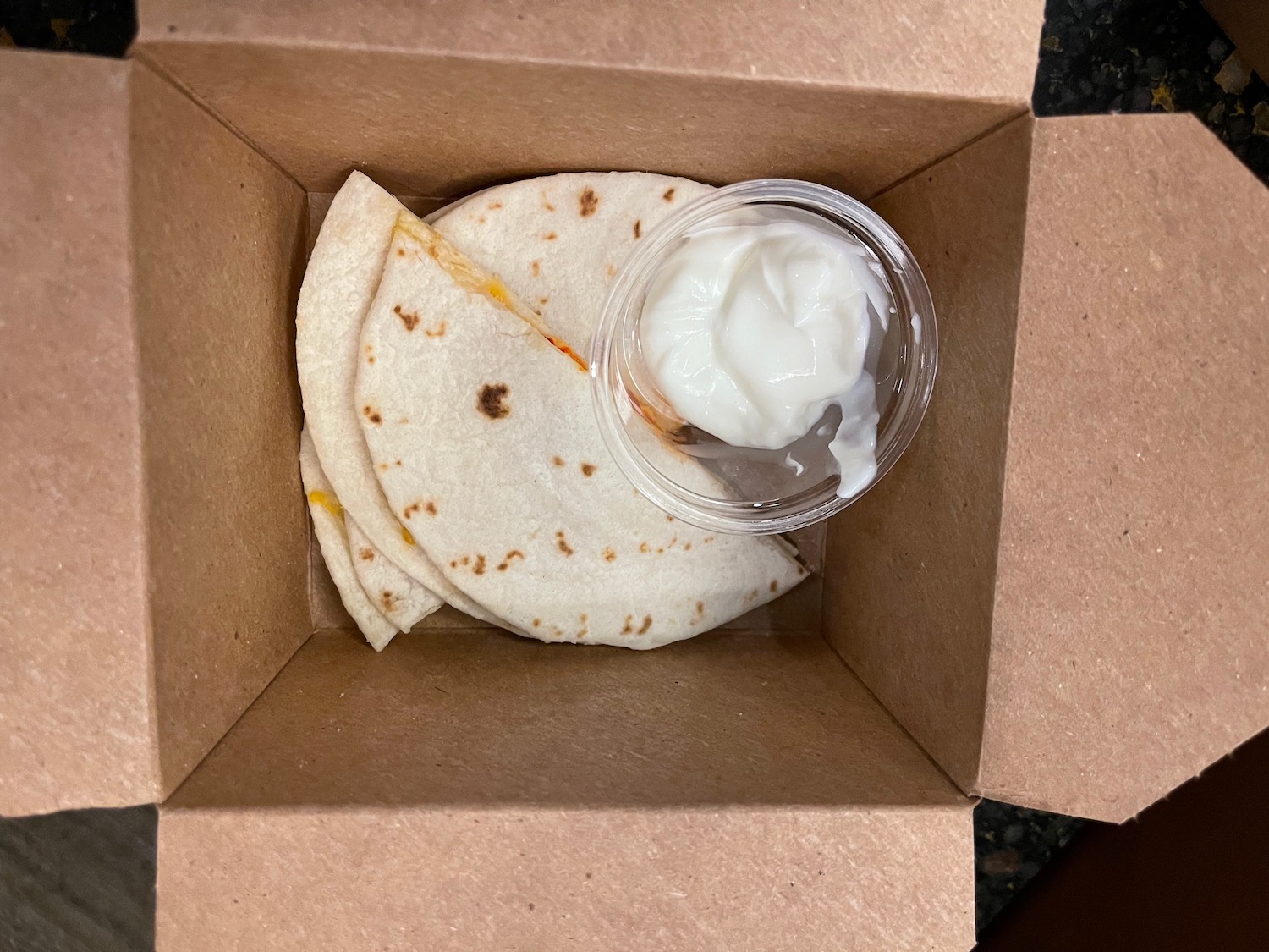 a box with tortillas and a container of yogurt