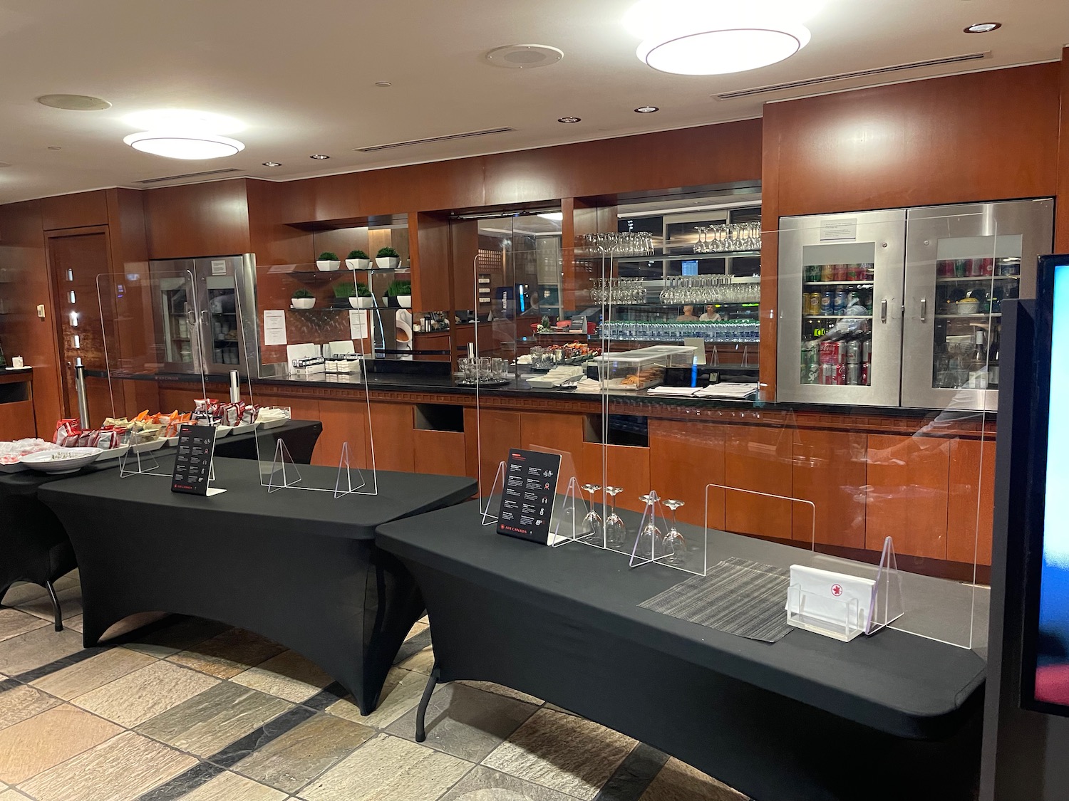 a buffet table with black tablecloths and a glass wall