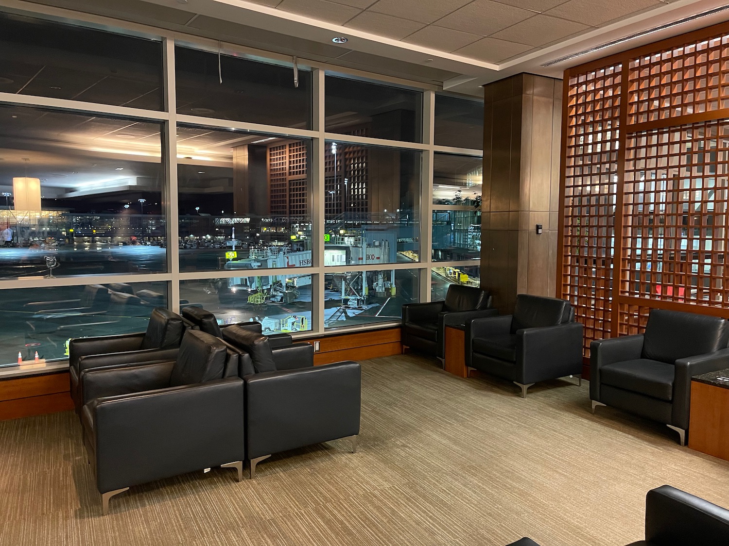 a room with black chairs and a large window