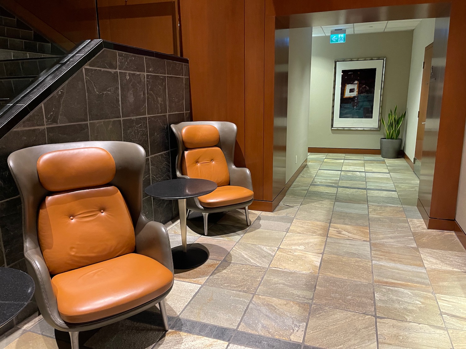 chairs in a hallway with a picture on the wall