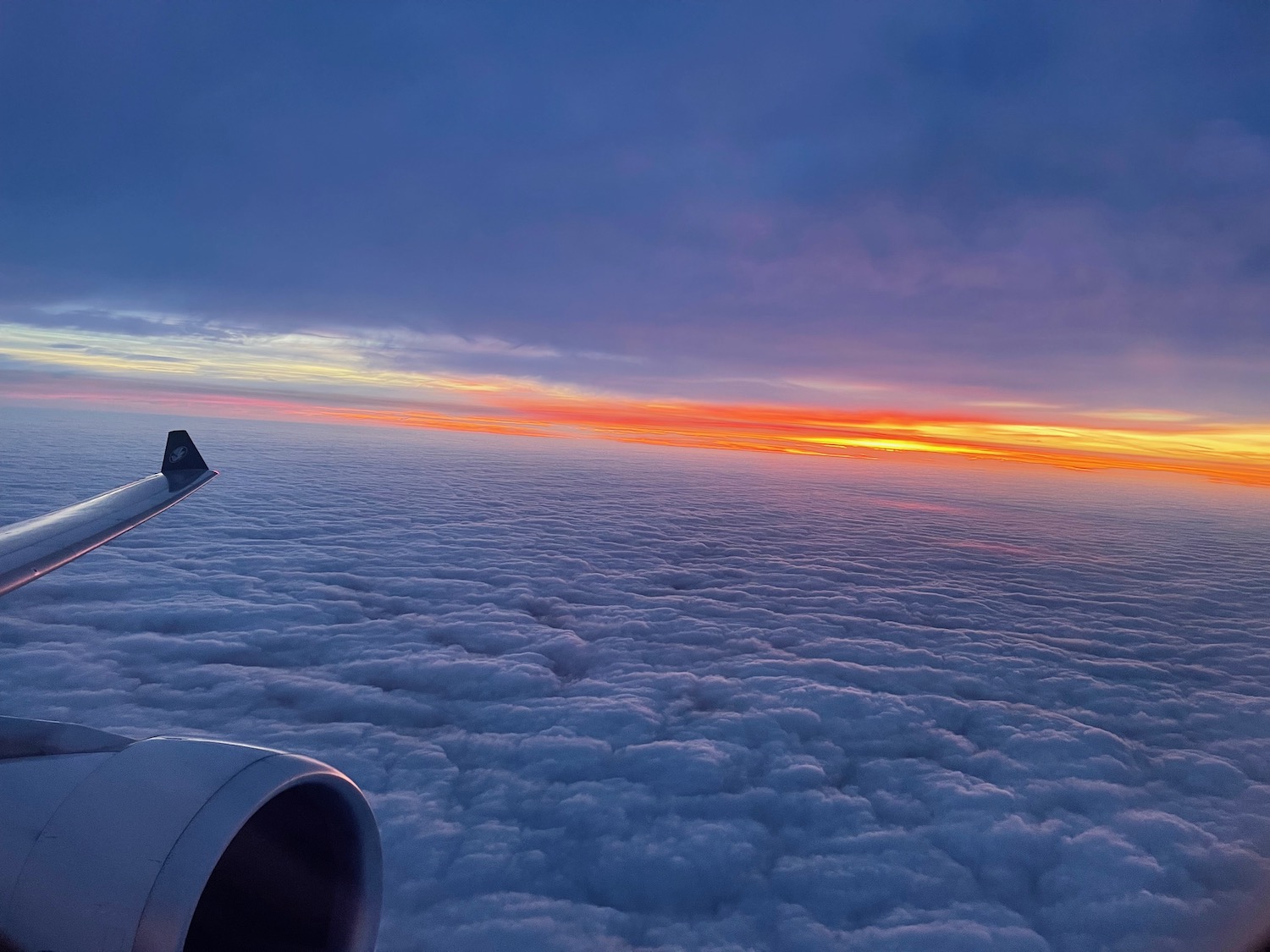 an airplane wing above clouds