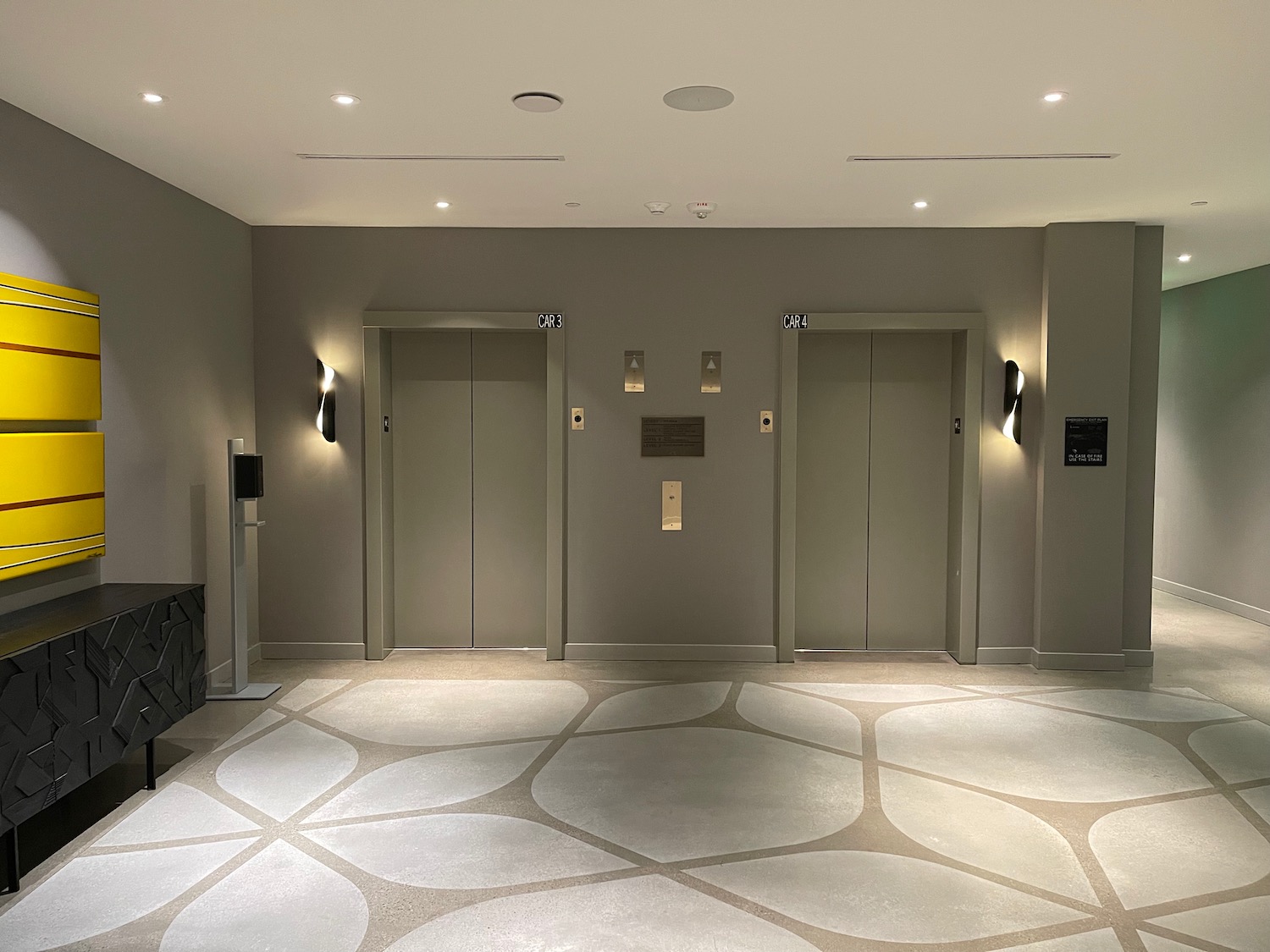 a room with two elevators and a tiled floor