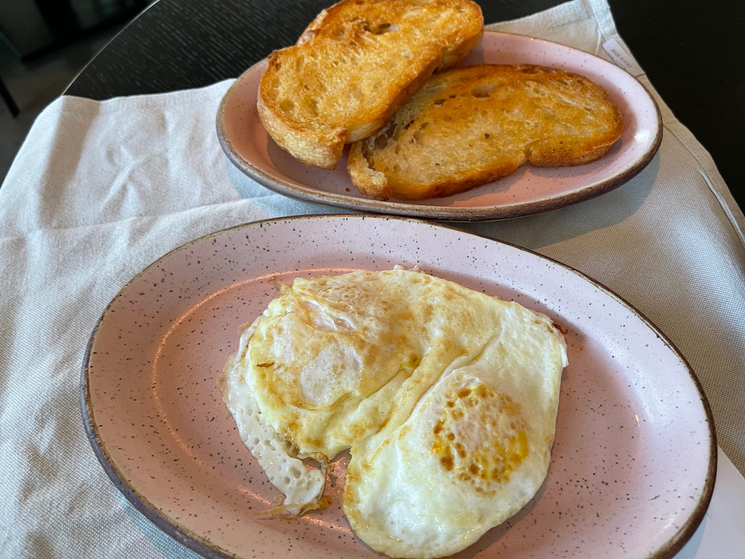 two plates of toast and eggs