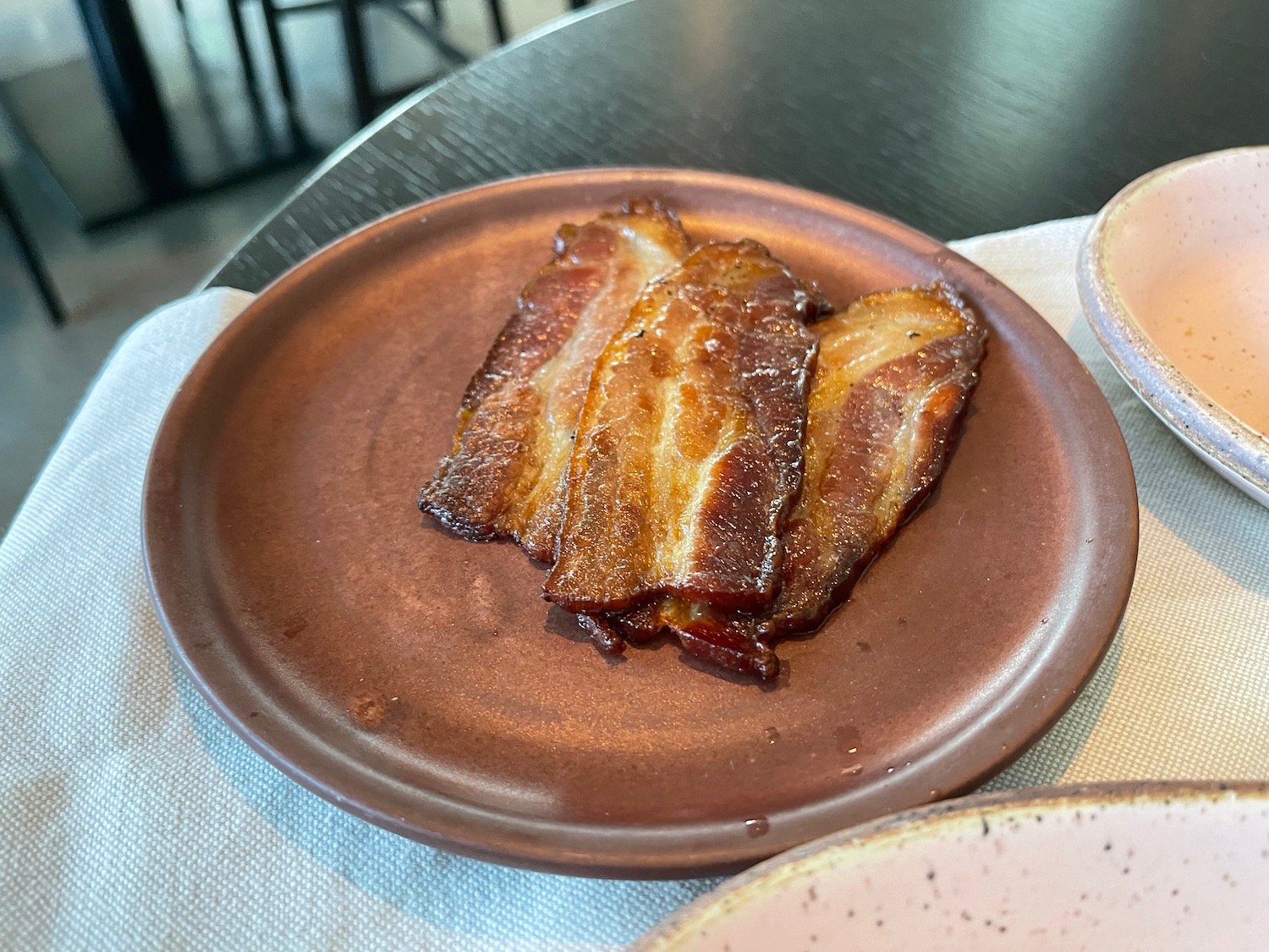 a plate of bacon on a table