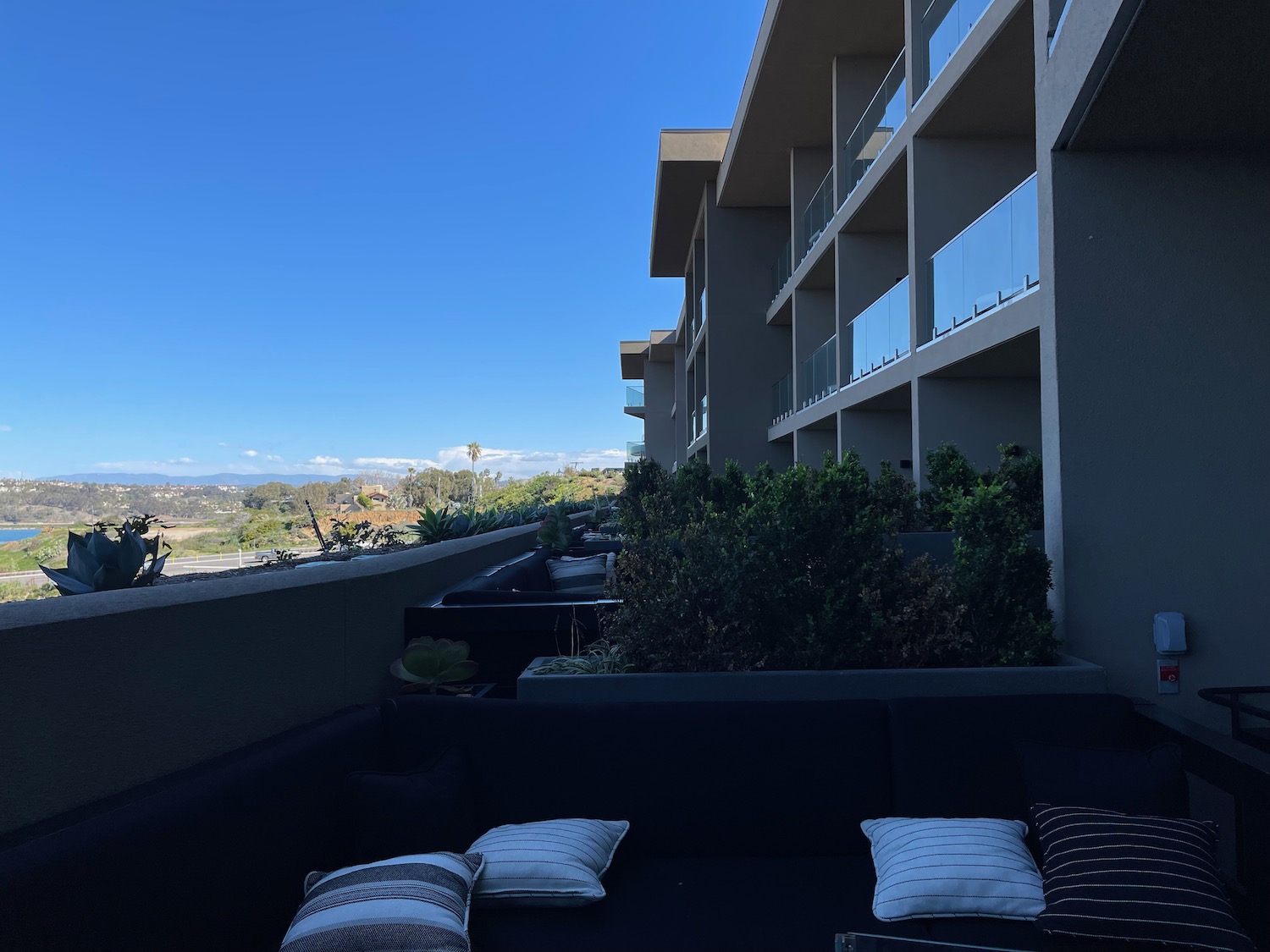 a couch with pillows on a balcony