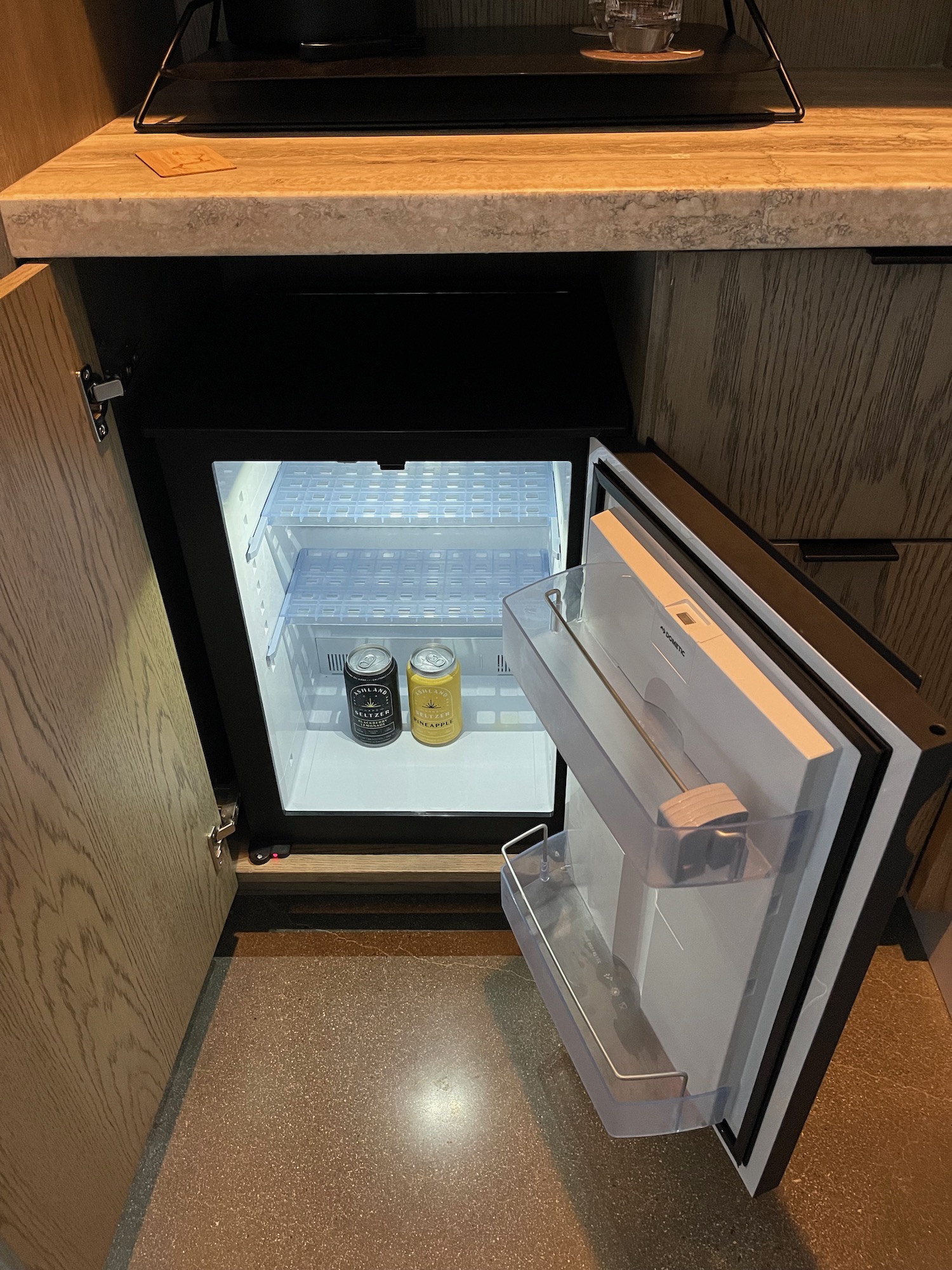 a small refrigerator with two cans of beer inside