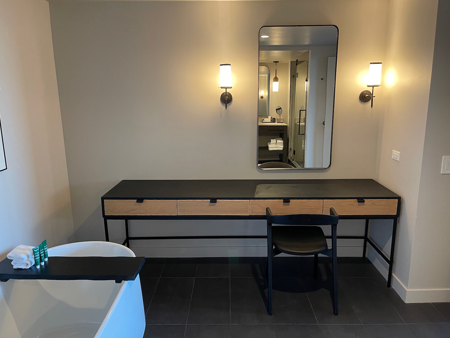 a bathroom with a mirror and a desk