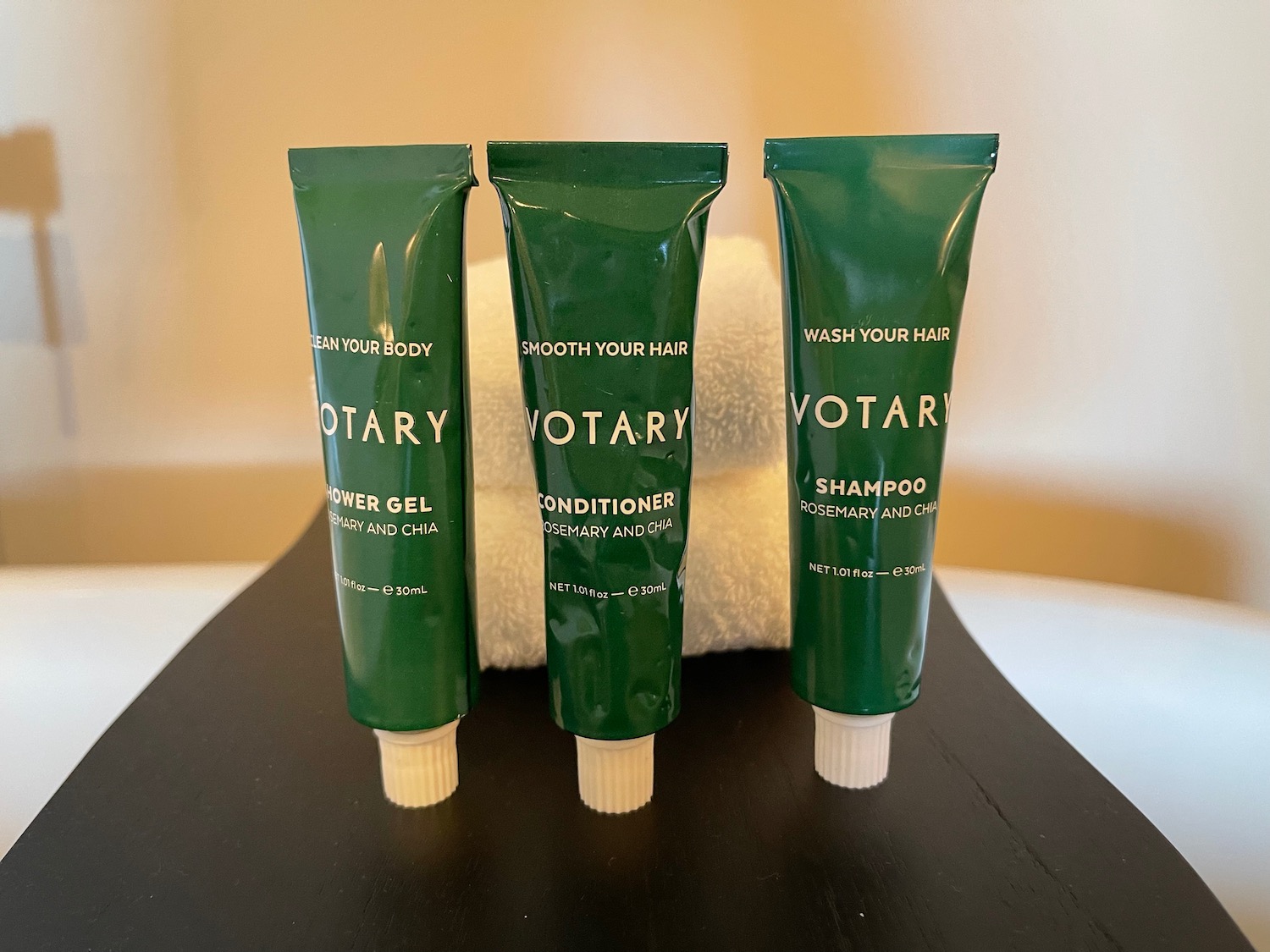 a group of green tubes of shampoo and conditioner