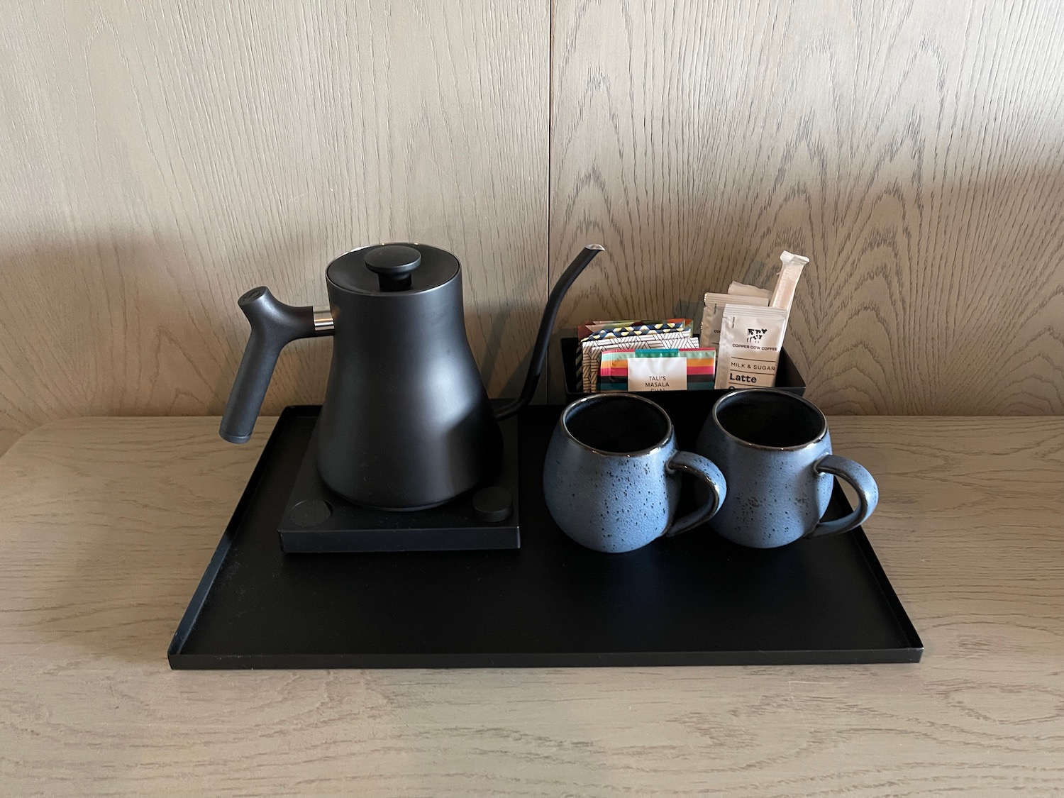 a tray with coffee and tea cups on it