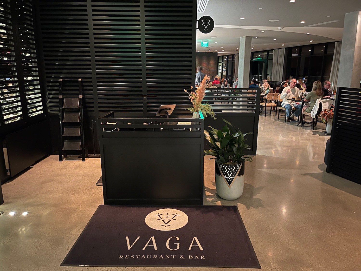 a restaurant with a black counter and a black rug