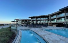 a pool and a building with a pool in the background