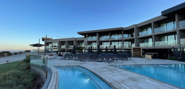 a pool and a building with a pool in the background